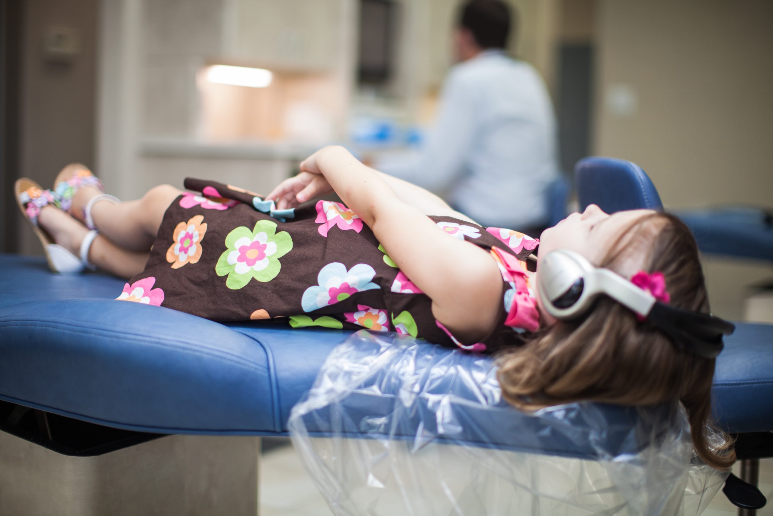 Young child being held during a friendly pediatric dental visit